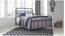 Nashburg black metal full bed staged in a bright bedroom
