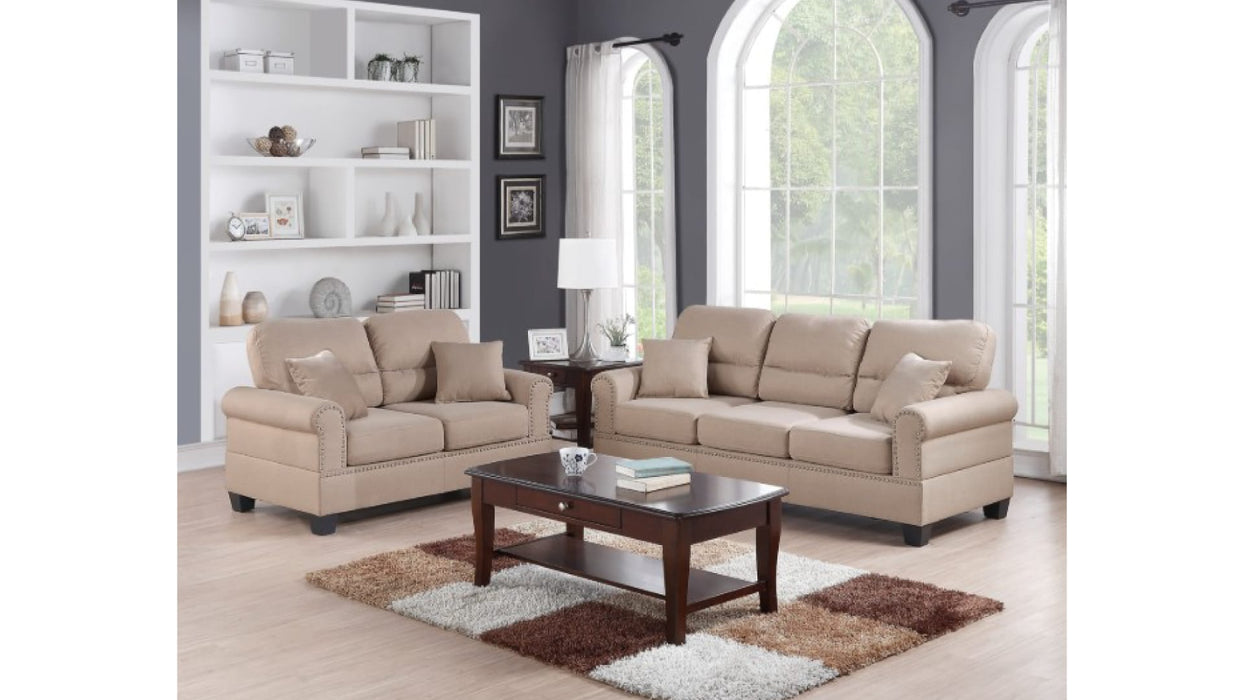 Shelton tan sofa and loveseat in a living room with bookshelves, wider view